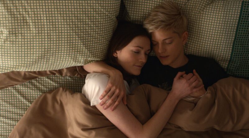 Image from Feel Good of Mae Martin and Charlotte Ritchie cuddling together in a bed