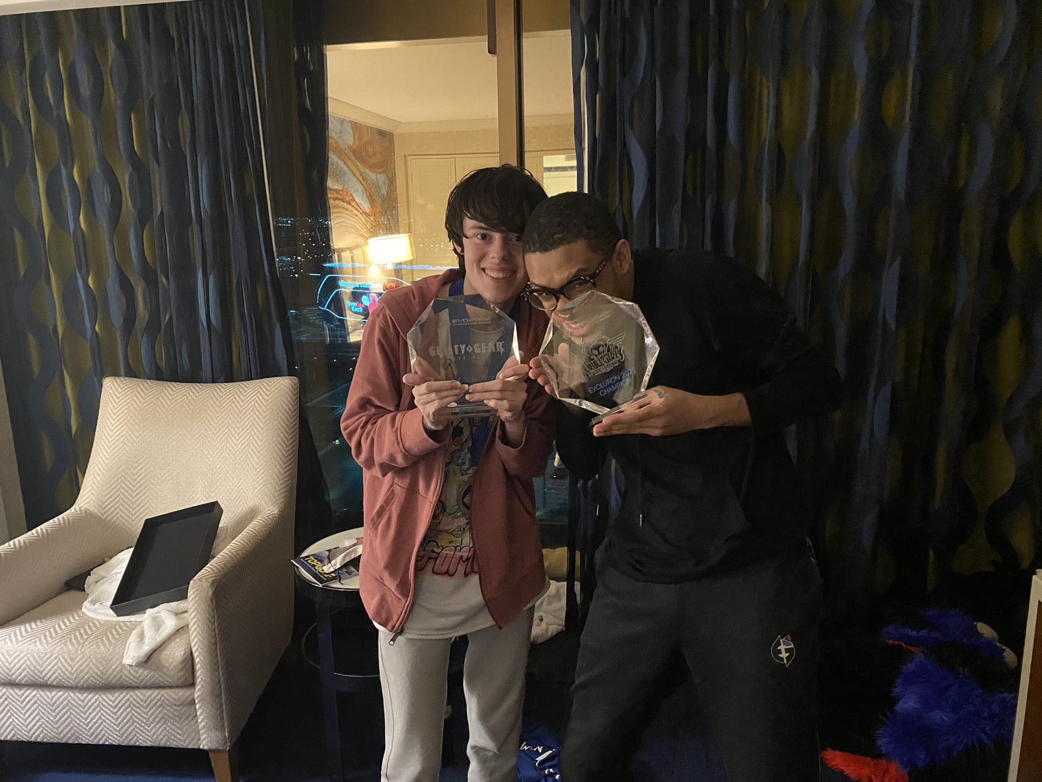 Photo of UMISHO and SonicFox posing together with their EVO 2022 trophies