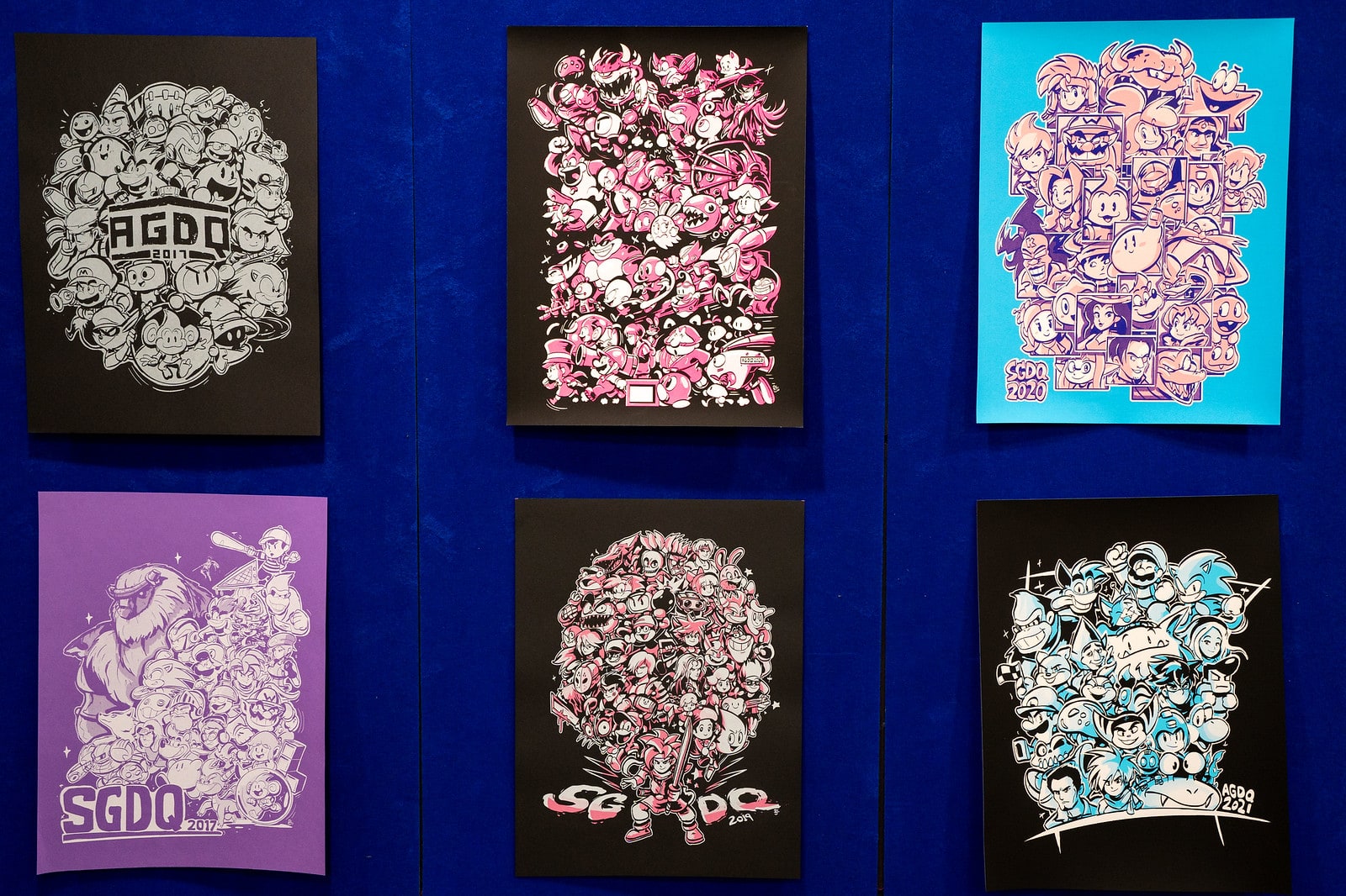 Photo of framed drawings from each year of GDQ