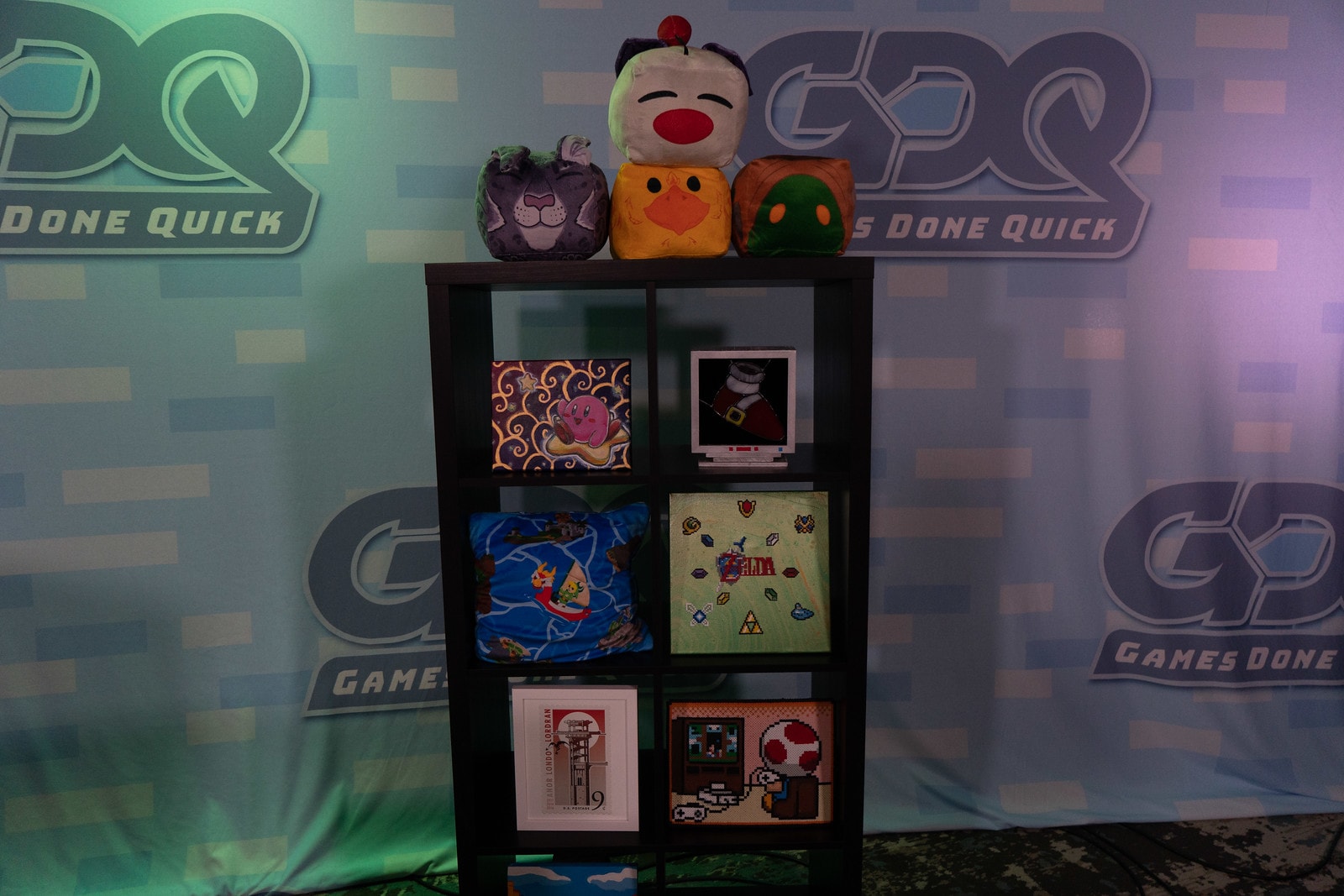 Photo of the Summer Games Done Quick background with a shelf full of video game memorabilia