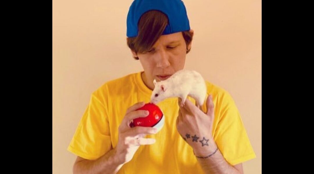 Photo of TeaAndToastie holding a pokeball up to a white rat