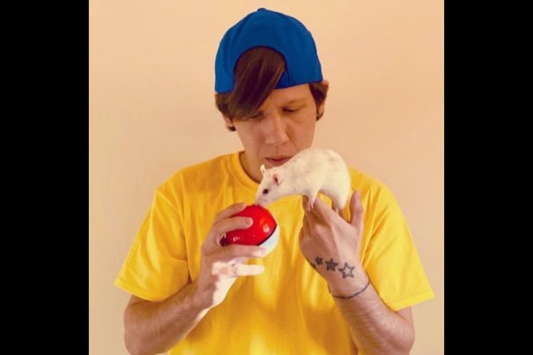 Photo of TeaAndToastie holding a pokeball up to a white rat
