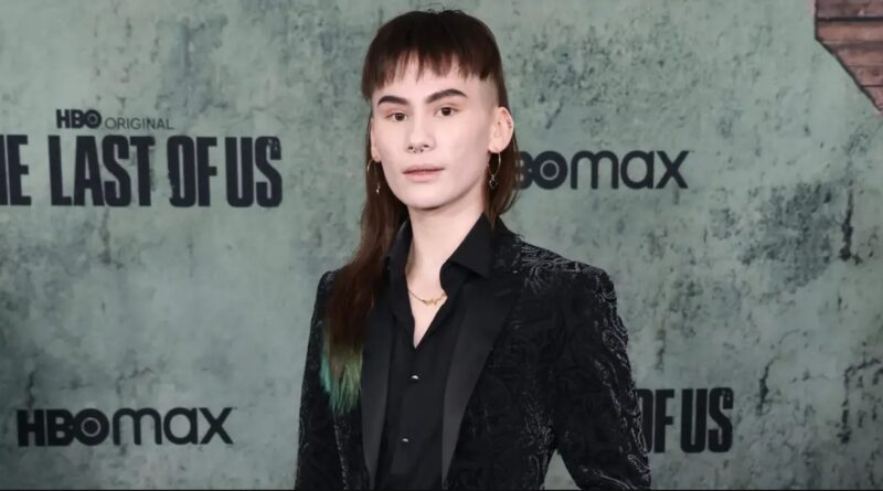 Actor Ian Alexander who played Lev in The Last of Us Part II standing in front of an HBO red carpet background