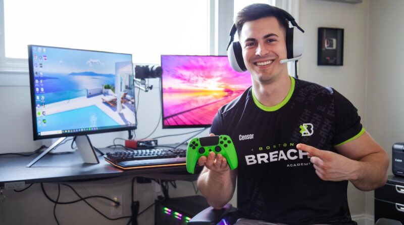 Doug "Censor" Martin Call of Duty holding a controller and pointing while wearing his Boston Breach Call of Duty League jersey